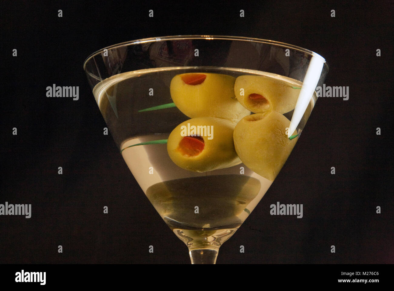A dry vodka martini with two olives on a dark background Stock Photo
