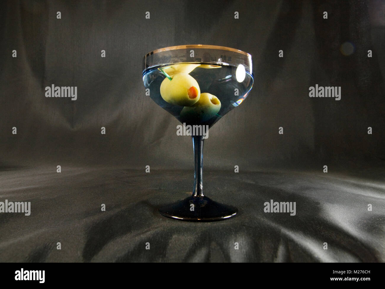 A dry vodka martini with two olives on a dark background Stock Photo