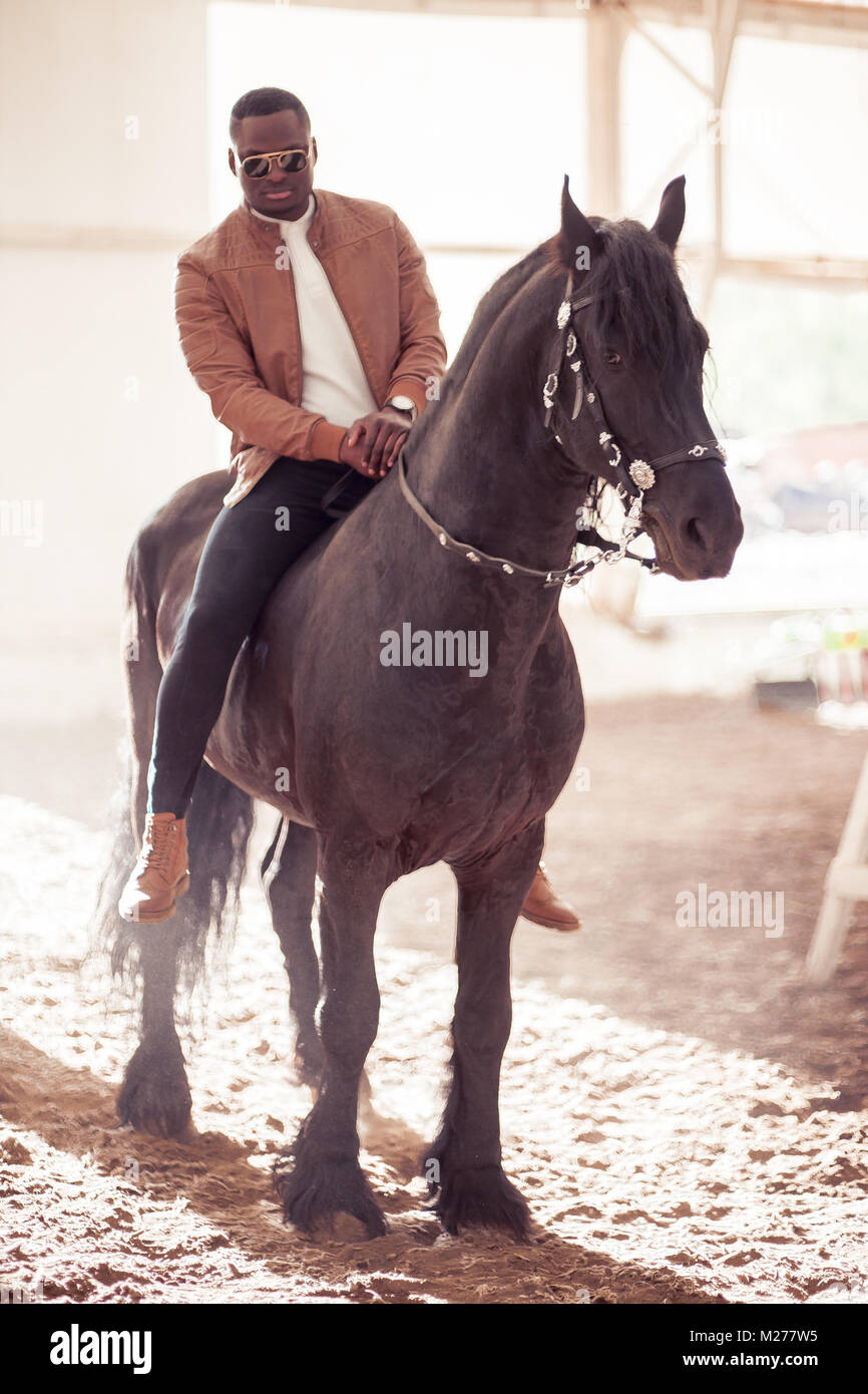 man riding brown horse on countryside Stock Photo - Alamy