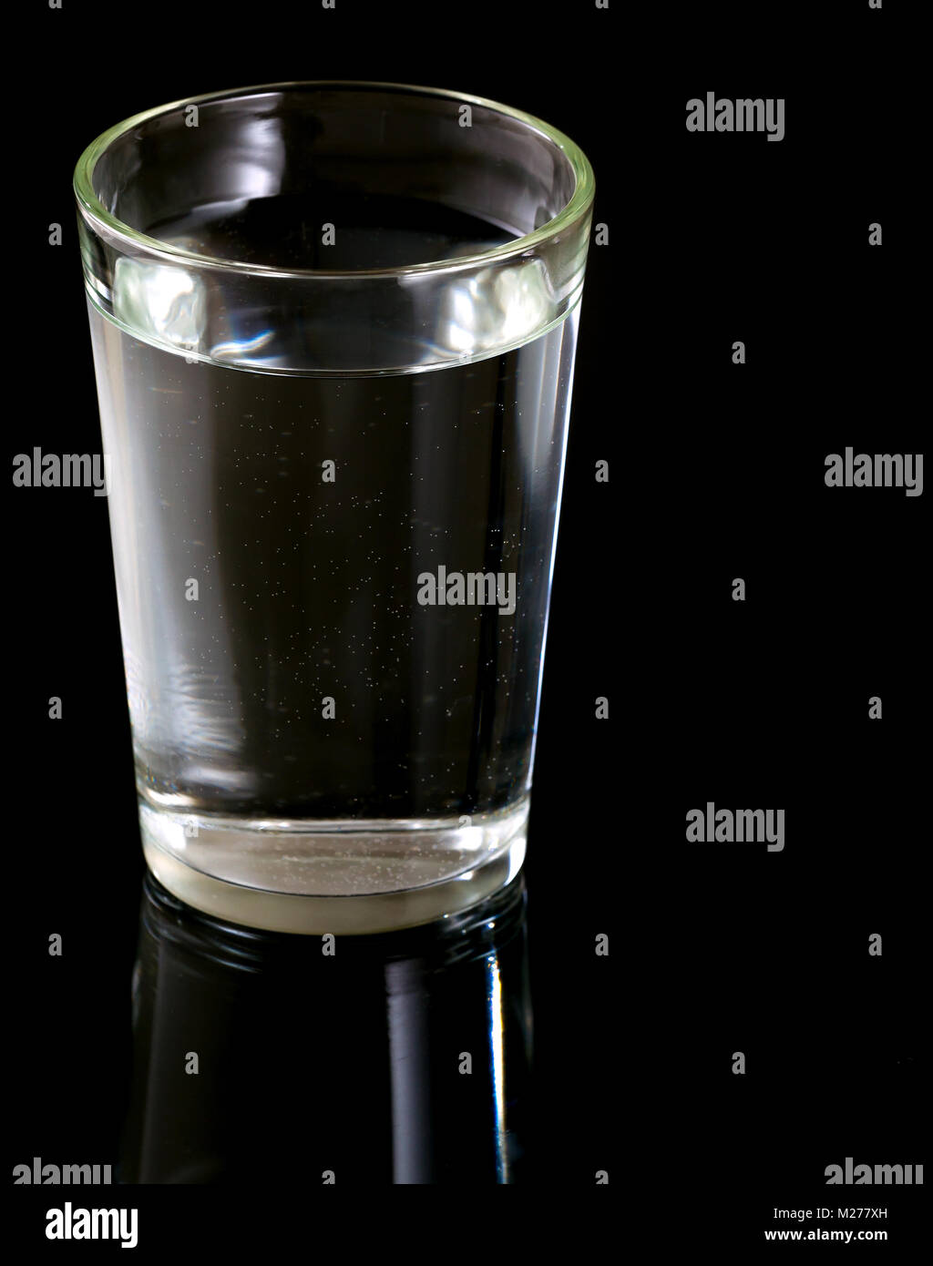Glass of water on black background Stock Photo - Alamy