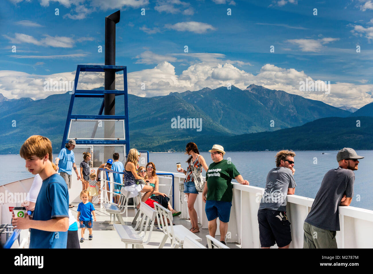 Passengers on MV Osprey 2000 ferry, Purcell Mountains in distance, crossing Kootenay Lake, Kootenay Region, British Columbia, Canada Stock Photo