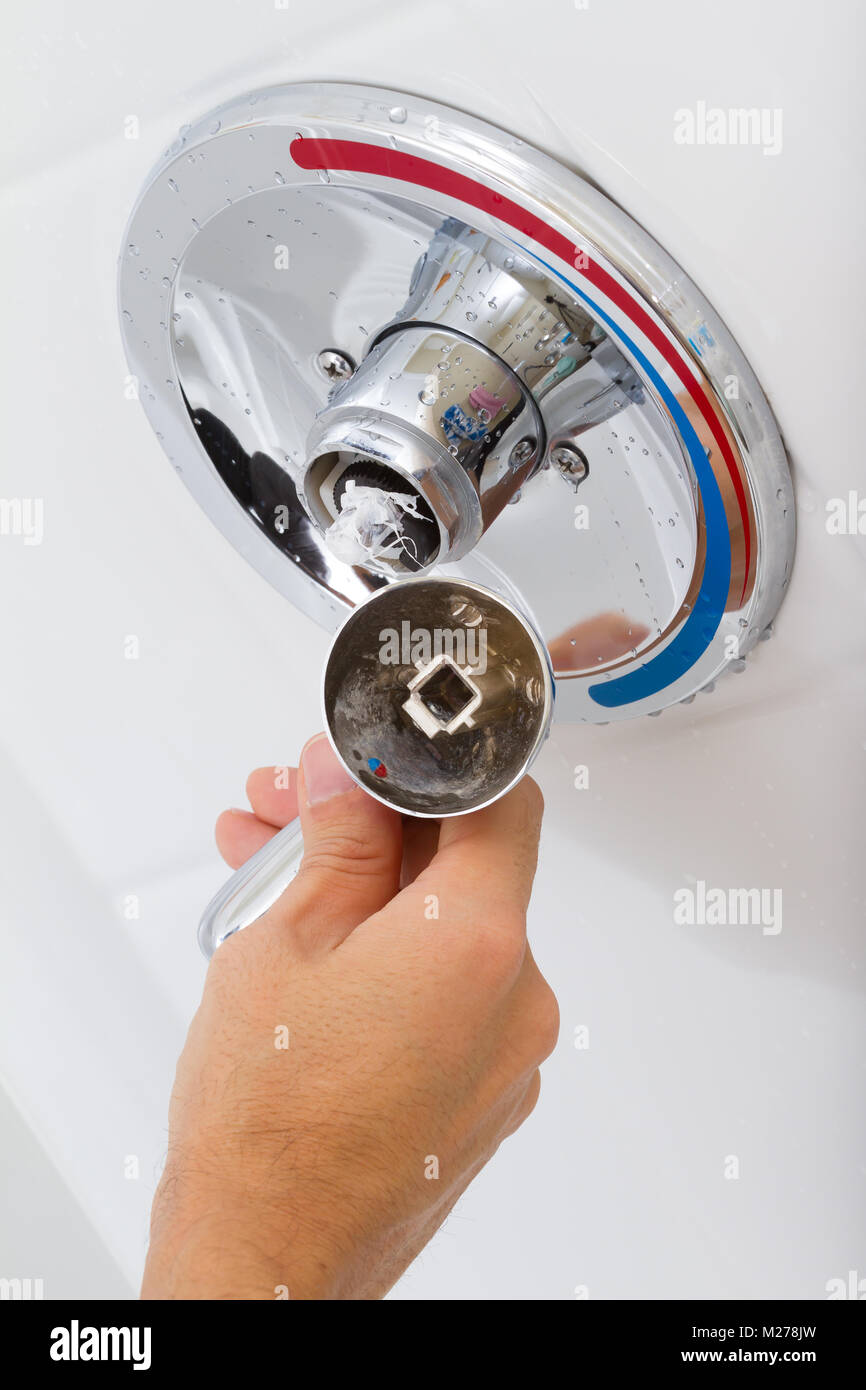 Broken Shower faucet cold and hot water in the bathroom Stock Photo