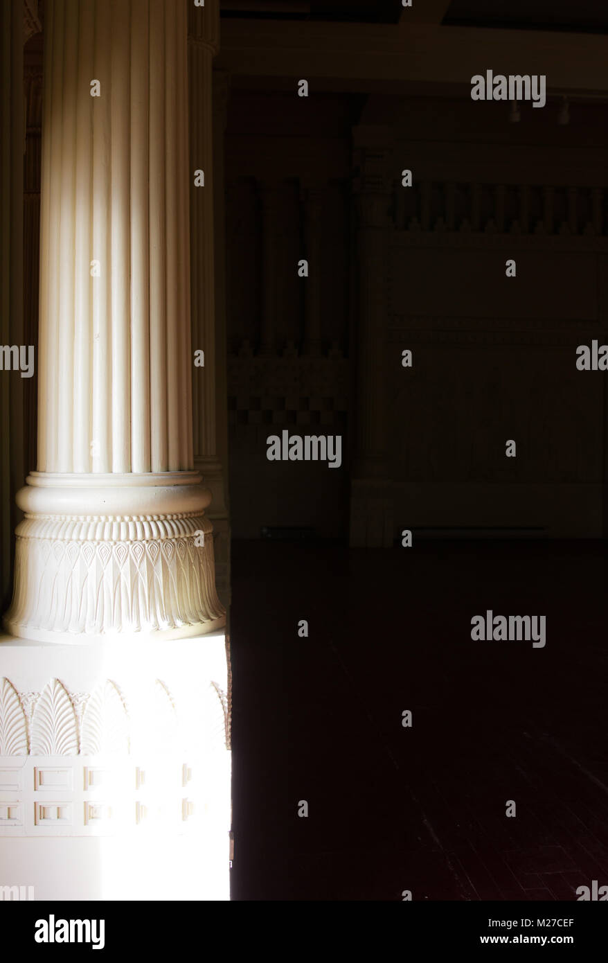 Light and shadow play across columns in an abandoned Masonic Temple in downtown Yakima, Washington Stock Photo