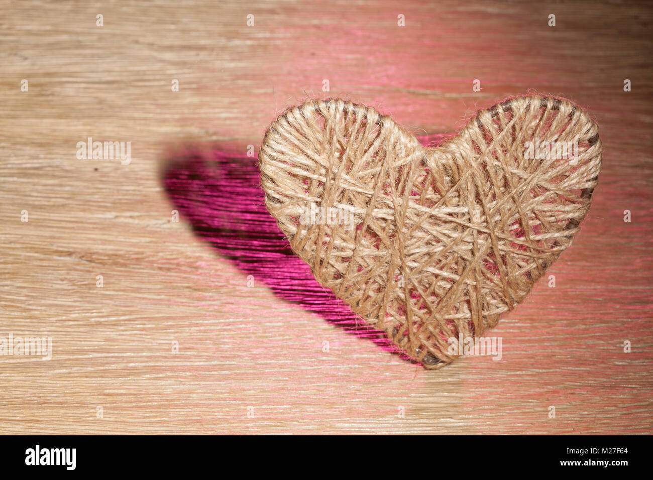 heart of linen thread on oak background Stock Photo - Alamy