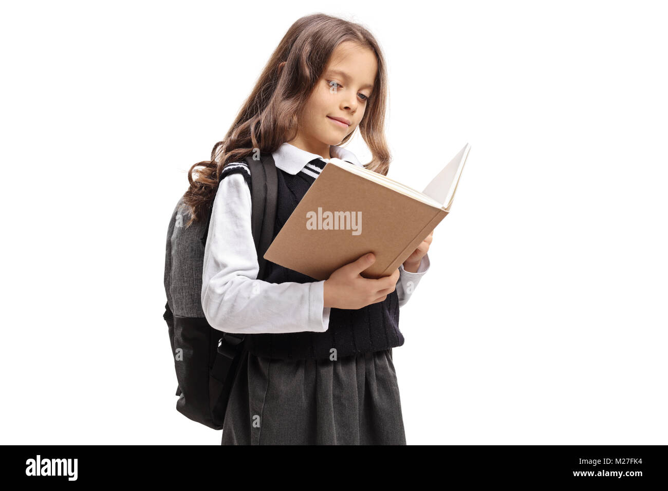 Schoolgirl reading a book isolated on white background Stock Photo - Alamy