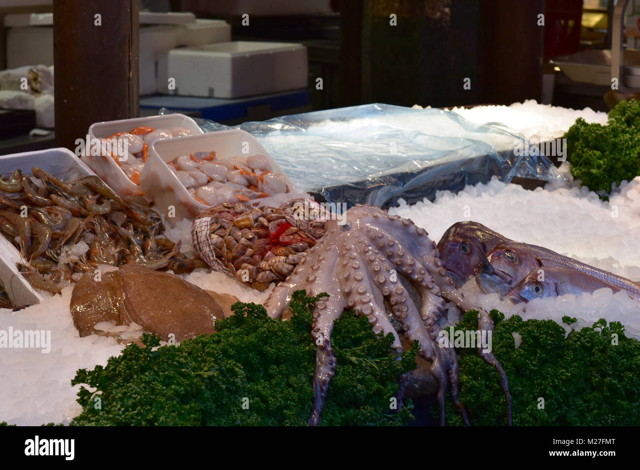 Fresh octopus and other shellfish for sale at a wet fishmongers stall