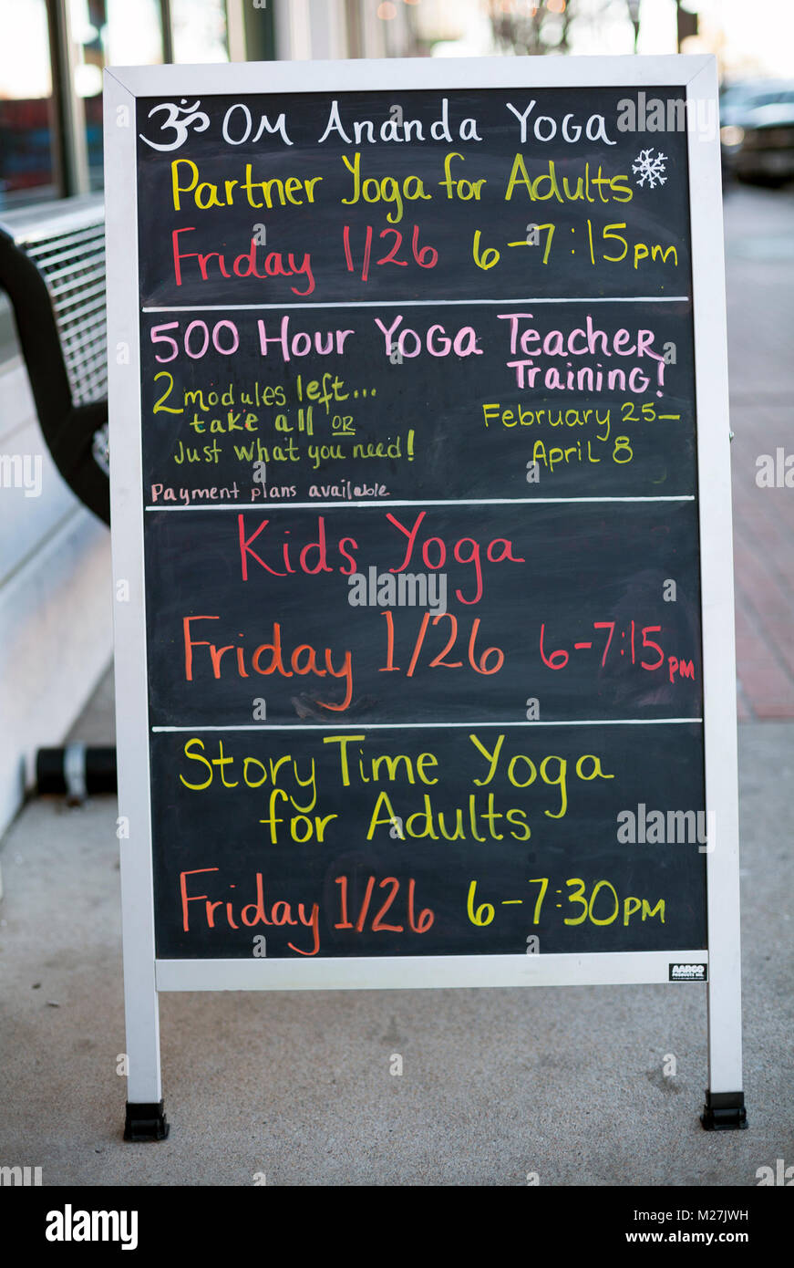 A sign advertises yoga classes. Stock Photo