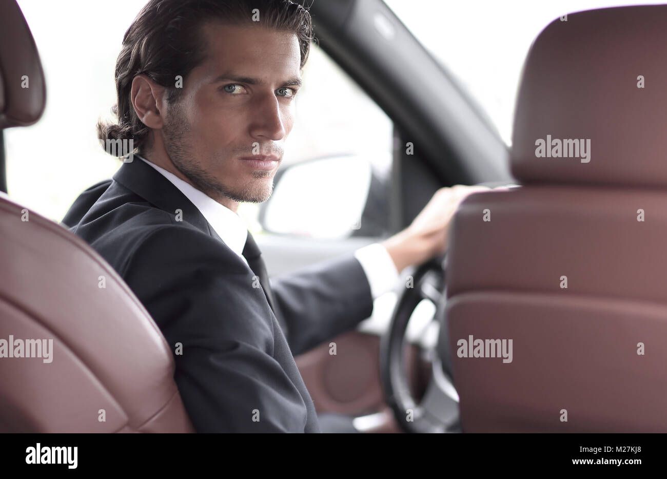 man sitting behind the wheel of a car Stock Photo - Alamy