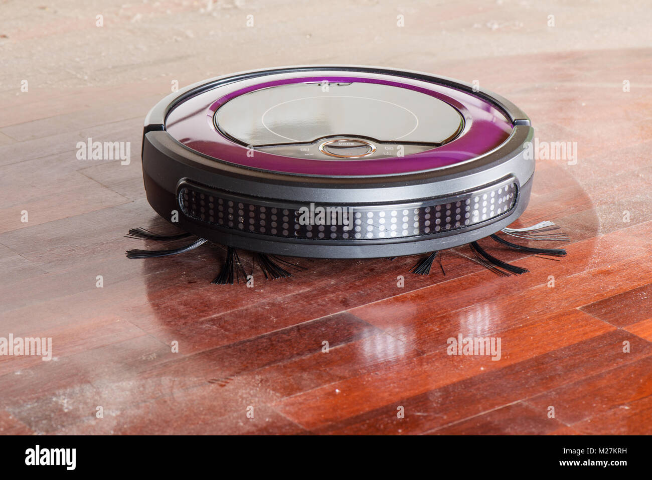robotic vacuum cleaner cleaning the dusty floor Stock Photo Alamy