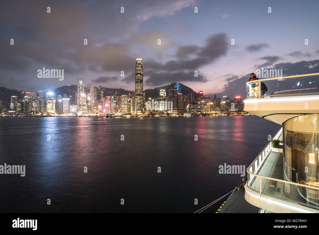 Hong Kong - January 25 2018: The viewing platform on the top of the Ocean cruise terminal in Kowloon with the Hong Kong island famous skyline at night Stock Photo