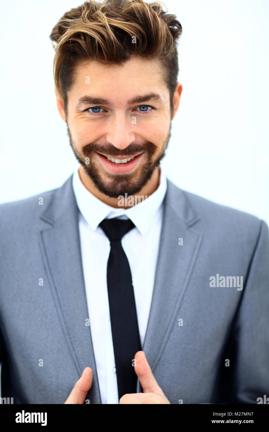 handsome young man in suit on grey background Stock Photo - Alamy