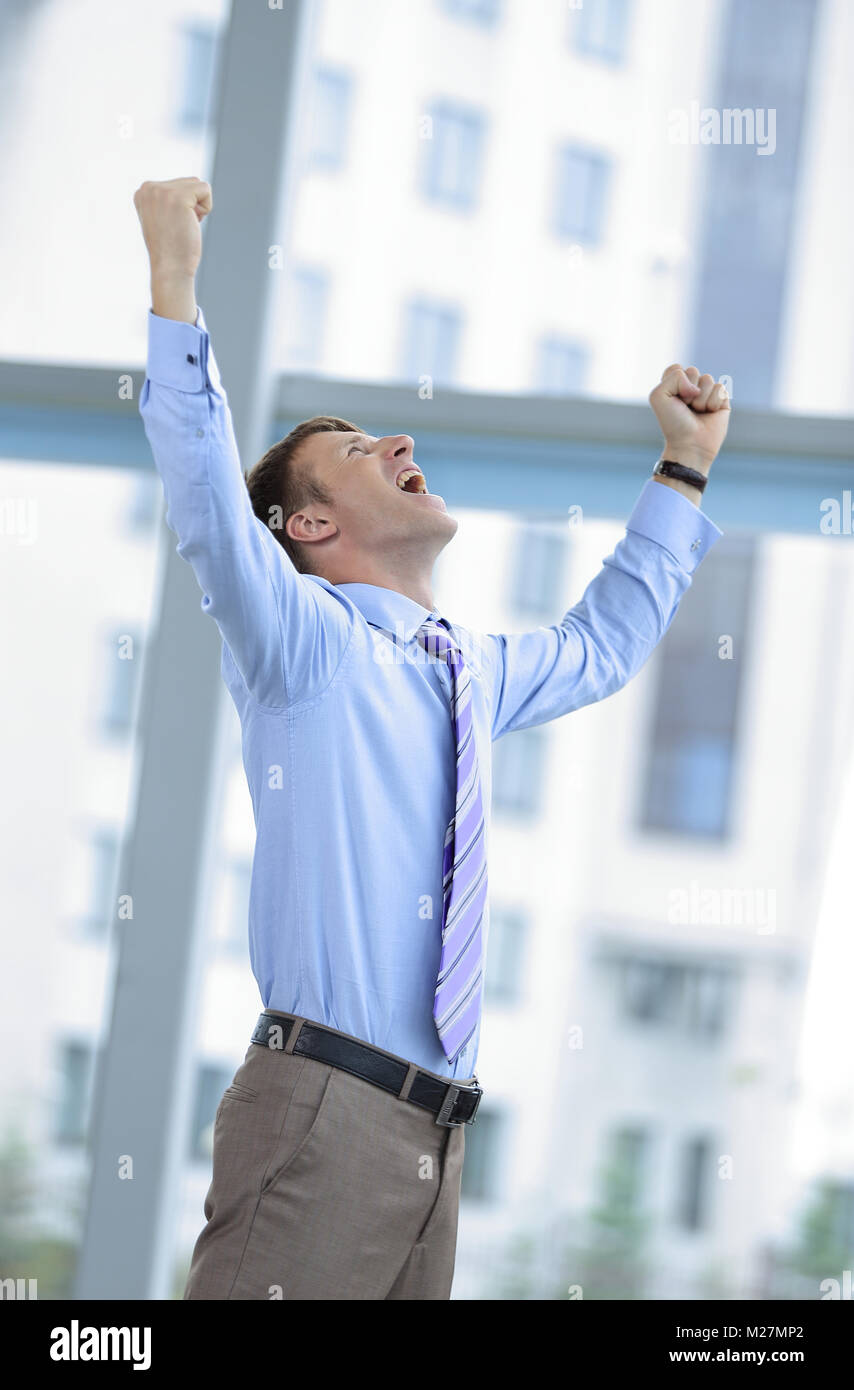 Businessman celebrating with his fists raised in the air Stock Photo ...