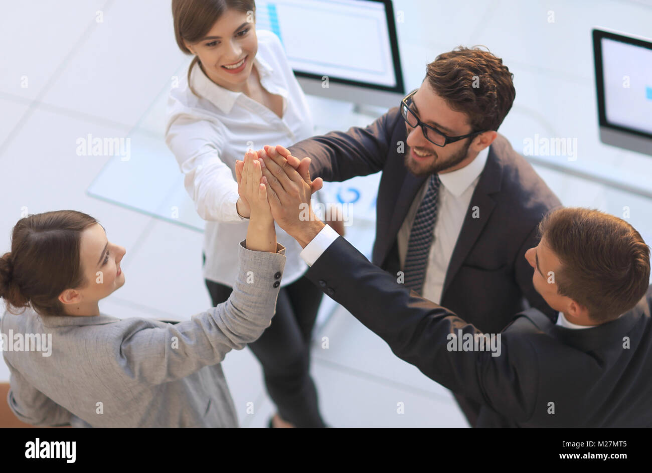 successful business team giving each other a high-five, standing in the ...