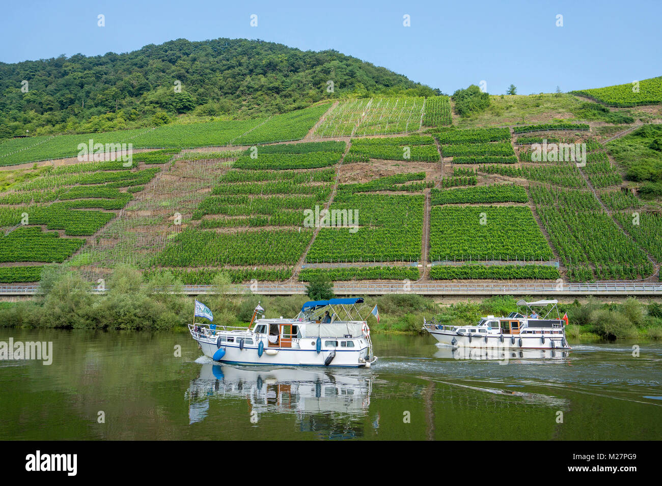 Two cabin boats on Moselle river at wine village Bruttig-Fankel, Rhineland-Palatinate, Germany, Europe Stock Photo
