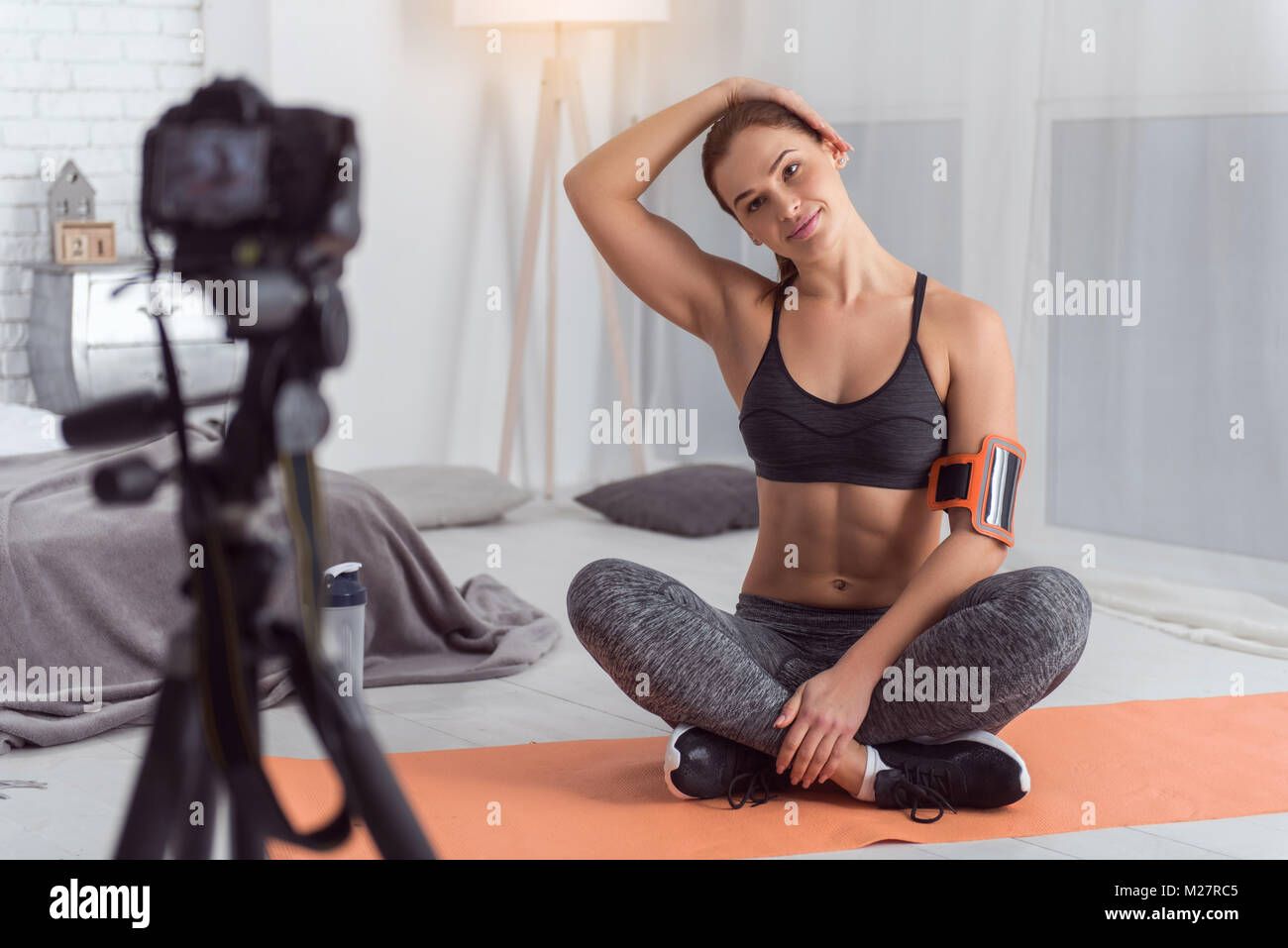 Joyful fit vlogger doing exercises for camera Stock Photo