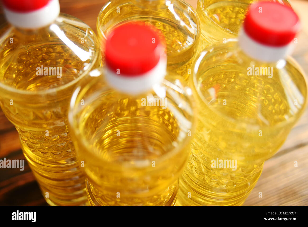 plastic bottles with sunflower oil on a wooden background Stock Photo