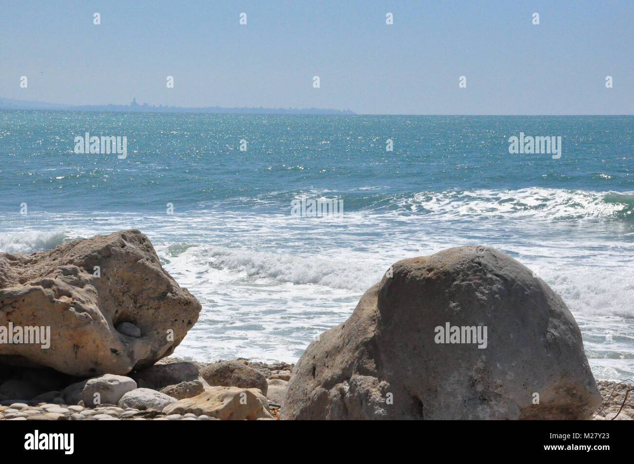 Beirut in the distance seen from rocky shore Stock Photo