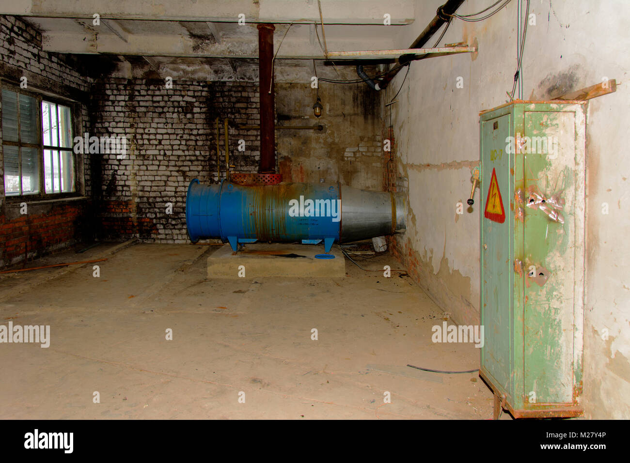 The old abandoned gas equipment for supplying hot air to the premises of the destroyed building of the bread factory. The structure of the times of th Stock Photo