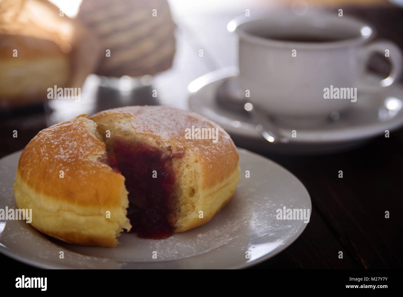 Berliner donut filled with strawberry jam. Close up Stock Photo