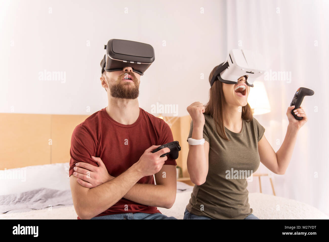 Appealing funny couple challenging in VR headsets Stock Photo Alamy