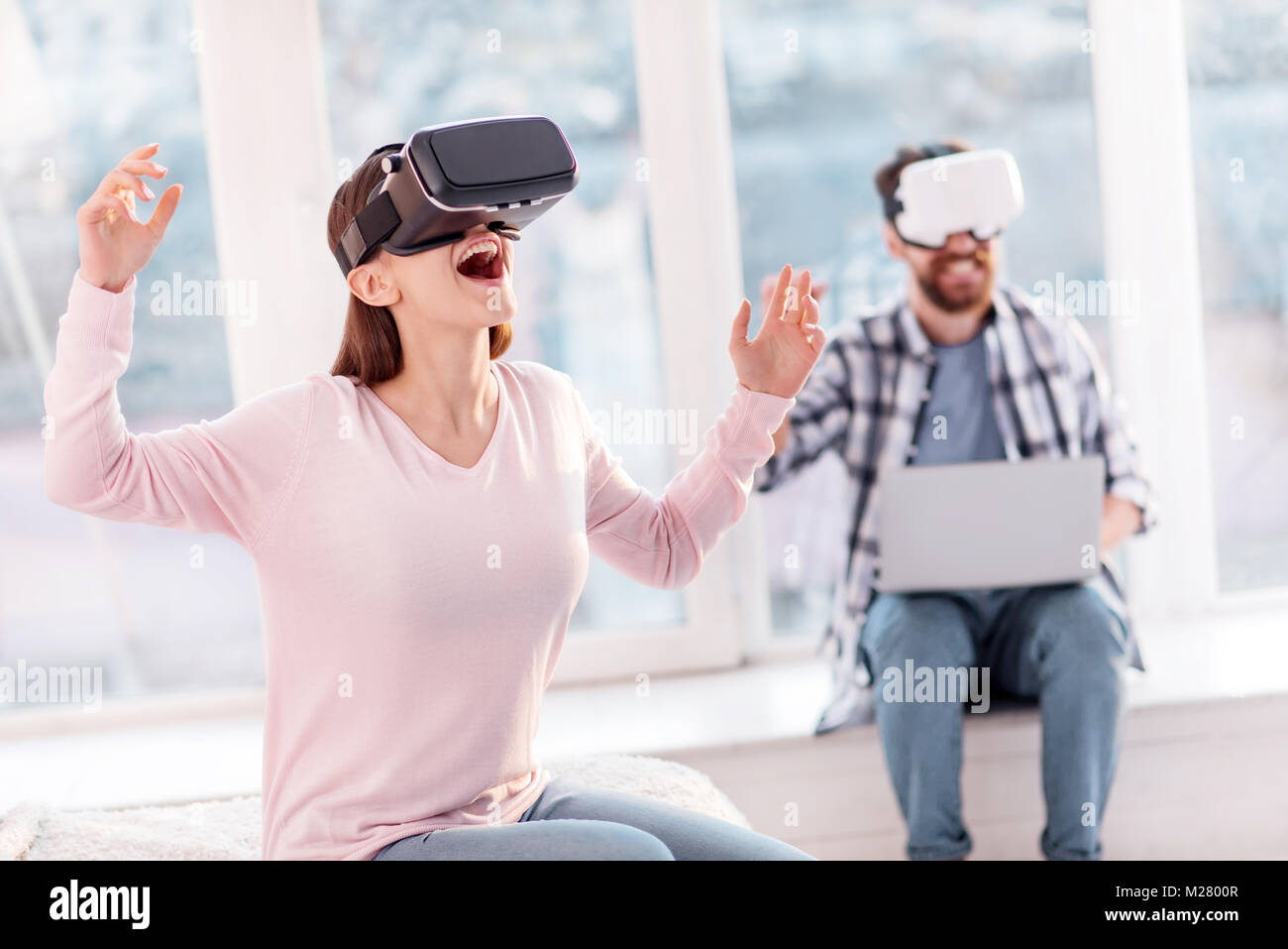 Cheerful gay woman having VR experience Stock Photo - Alamy