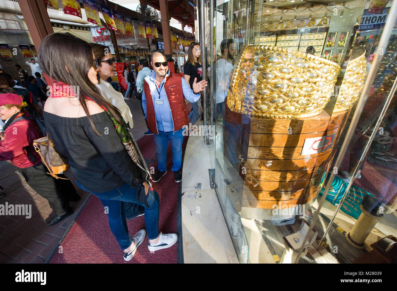 DUBAI, UNITED ARAB EMIRATES - JAN 02, 2018: Tourists are looking at the largest golden ring in the world, it weighs almost 64 kilograms. The ring is i Stock Photo
