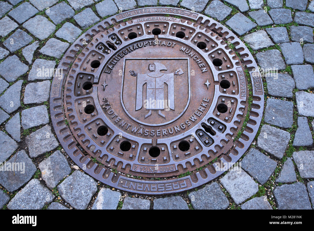 Manhole cover with Münchner Kindl, City of Munich, Upper Bavaria, Bavaria, Germany Stock Photo