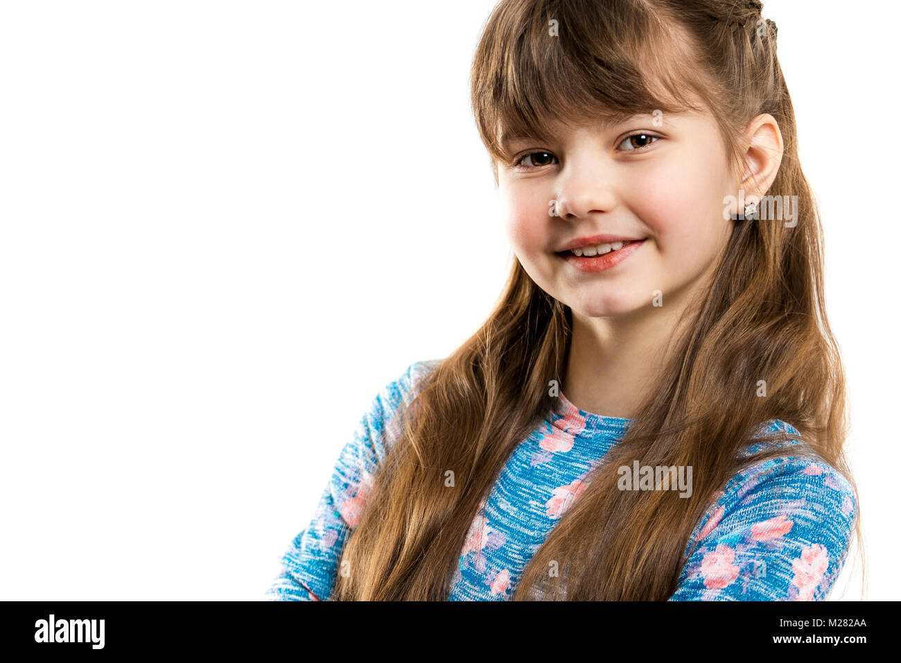 Portrait of a beautiful little smiling girl on a white background. Child's face closeup Stock Photo