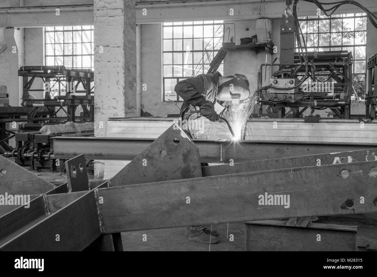 monochrome photo of a worker performing gas welding work Stock Photo
