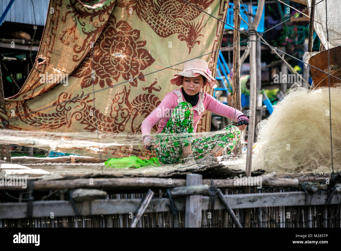 cambodia net fishing Cambodian woman mending fishing net, Kampong Phluk Floating Village, Siem  Reap Province, Cambodia Stock Photo