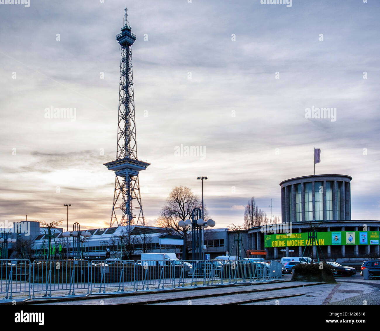 Berlin-Westend.Berliner Funkturm radio tower steel framework & Berlin Expocenter City Trade Fair Rotunda building at sunset Stock Photo