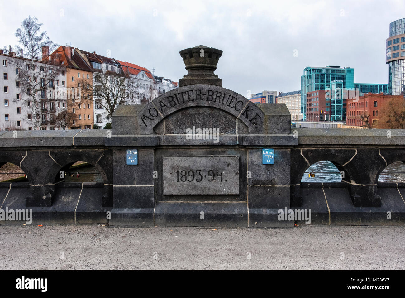 Berlin,Mitte,Moabit.Urban landscape.Historic old Moabit bridge over the river Spree,apartment buildings,modern hotel & office buildings Stock Photo