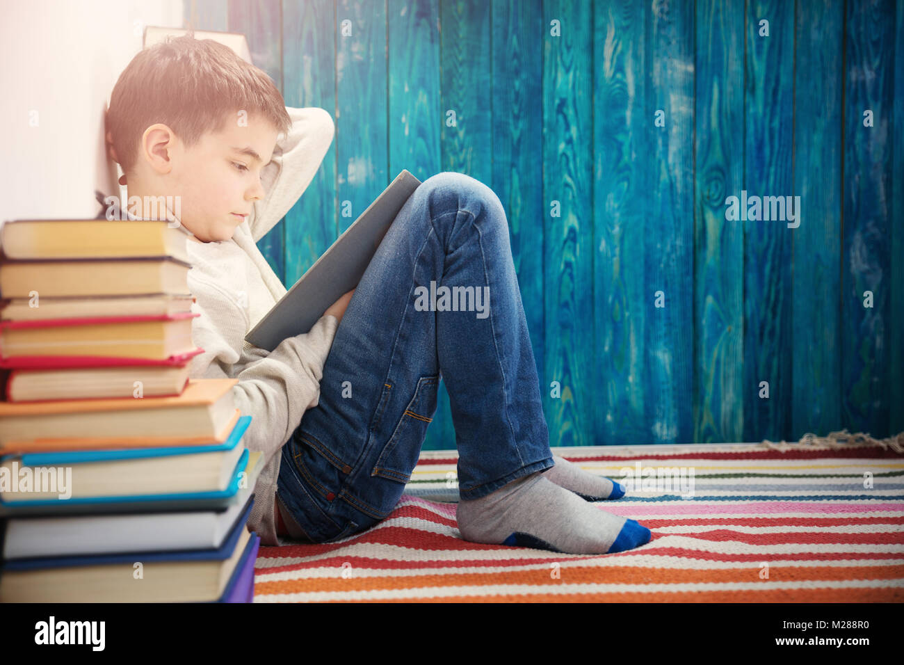 eight years old child reading a book Stock Photo Alamy