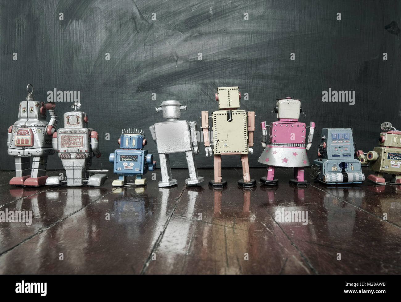 retro-robots-at-school-looking-at-a-blackboard-toned-image-stock-photo