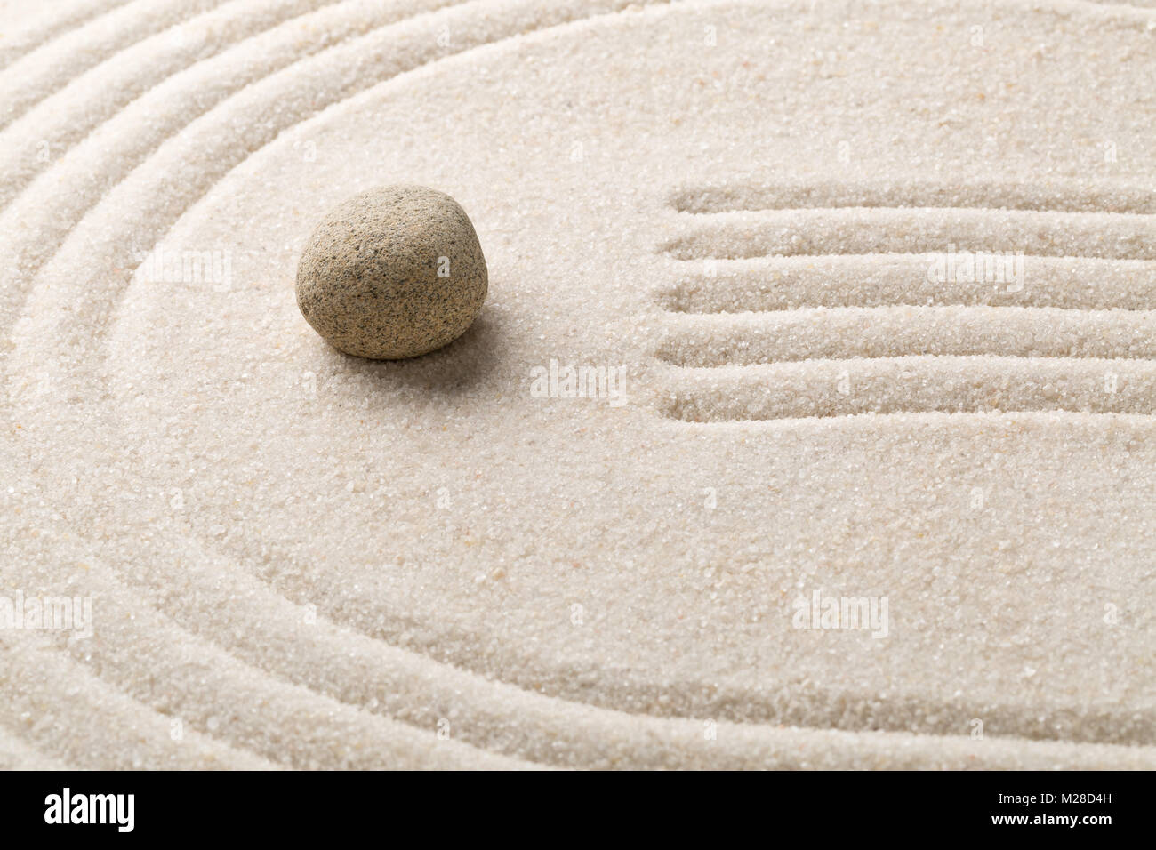 Zen sand and stone garden with raked lines and curves with selective ...