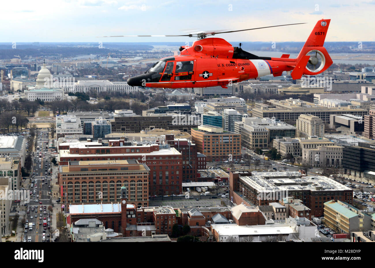 A Coast Guard MH-65 Dolphin helicopter crew from Air Station Atlantic City flies past the Capitol Building as they provide security for the State of the Union address in Washington D.C., Jan. 30, 2018. Crews from Air Station Atlantic City support the National Capital Region Air Defense Facility (NCRADF) by supplying multiple aircraft to assist the North American Aerospace Defense Command (NORAD). U.S. Coast Guard Stock Photo