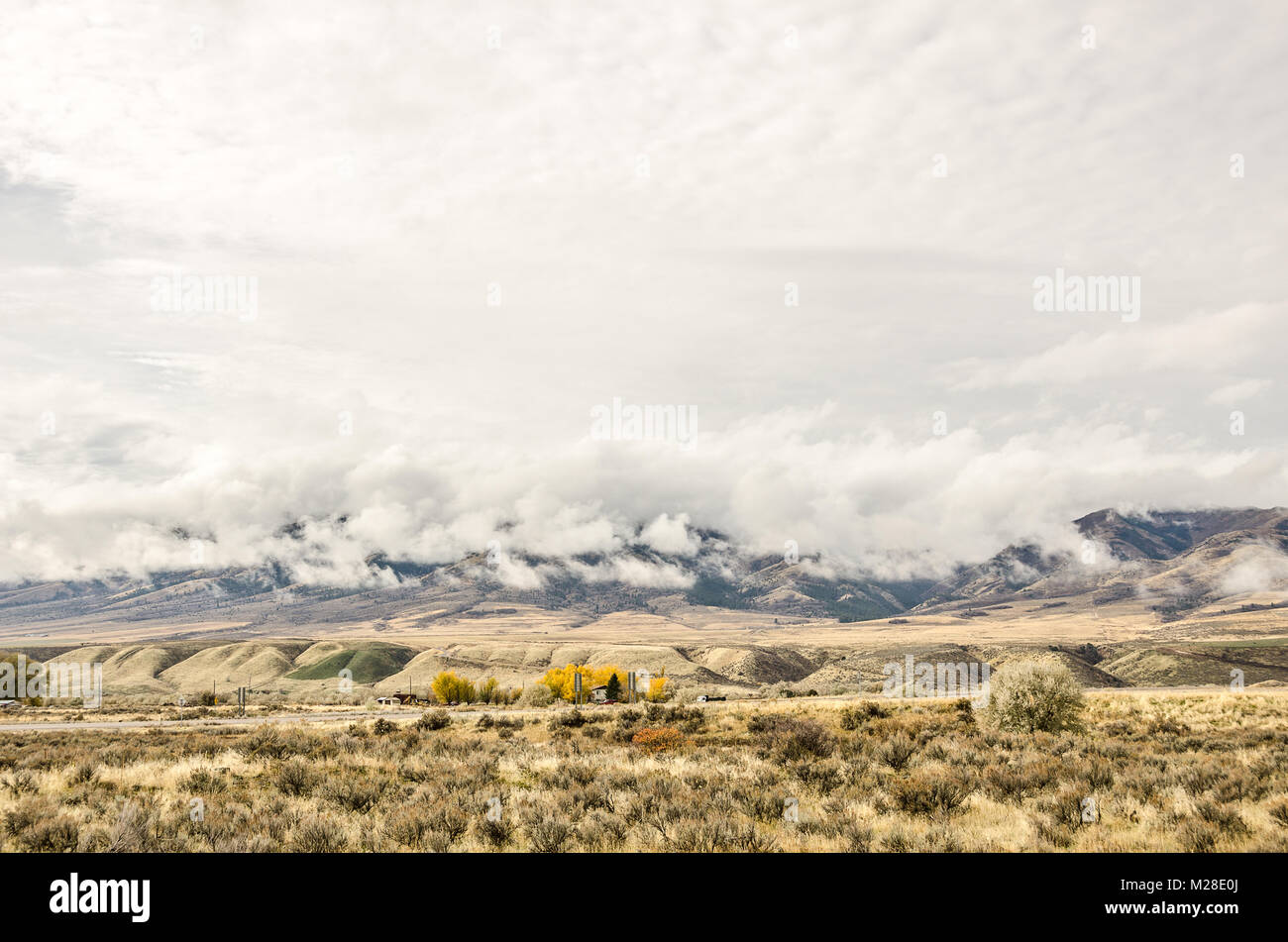 Layers of clouds hanging over the mountains on an overcast day Stock Photo