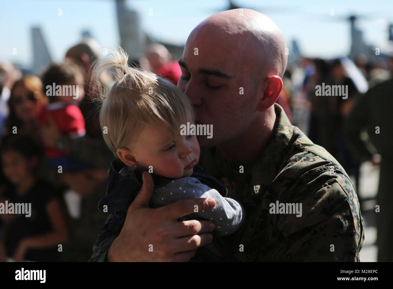 A father reunites with his son following the 15th Marine Expeditionary Unit’s aviation combat element’s return to Marine Corps Air Station Miramar, Calif., Feb. 1. During the deployment, more than 4,500 Marines and Sailors of the America Amphibious Readiness Group and embarked 15th MEU conducted maritime security operations and multiple military-to-military exchanges with partner nations in support of regional security, stability and the free flow of maritime commerce in the Indo-Asia-Pacific and Middle East regions. Stock Photo