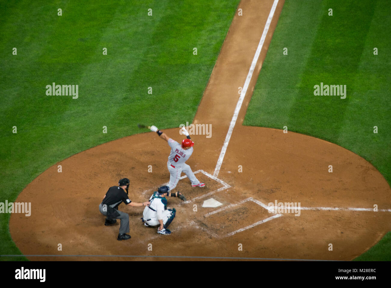 Albert Pujols from the Los Angeles Angels swings at a pitch during a game against the Seattle Mariners. Stock Photo