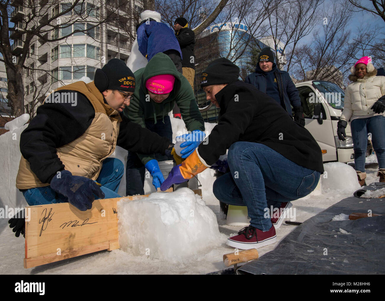 SAPPORO, Japan (Feb. 3, 2018) Sailors from Arleigh Burke-class guided-missile destroyer USS Mustin (DDG 89) construct a bollard out of snow while assisting the 2018 Navy Snow Team during the 69th Annual Sapporo Snow Festival. This is the 35th year the U.S. Navy has sent a team to participate in the event. (U.S. Navy Stock Photo