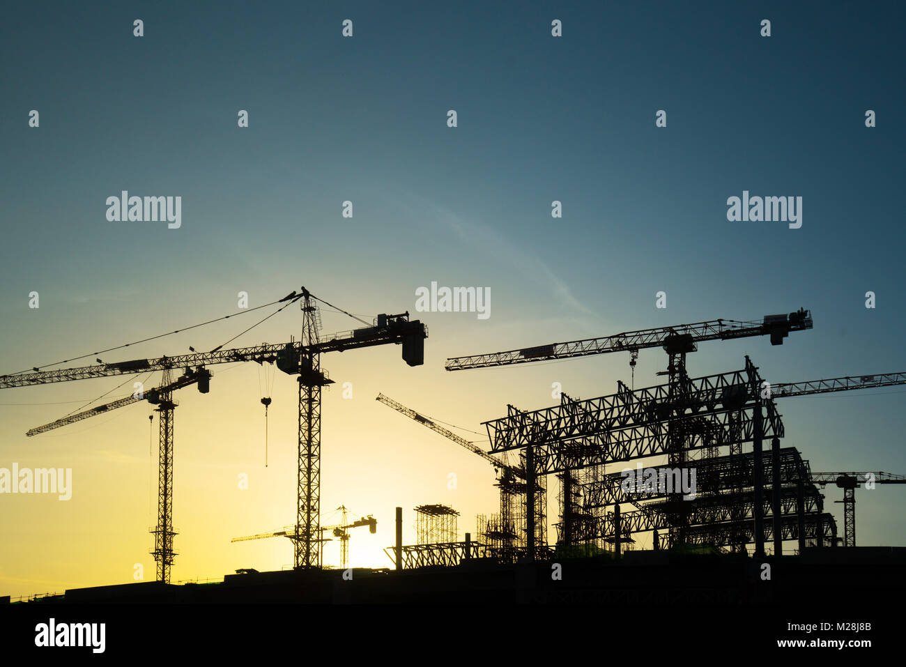 construction crane over tower building site silhouette sunrise ...