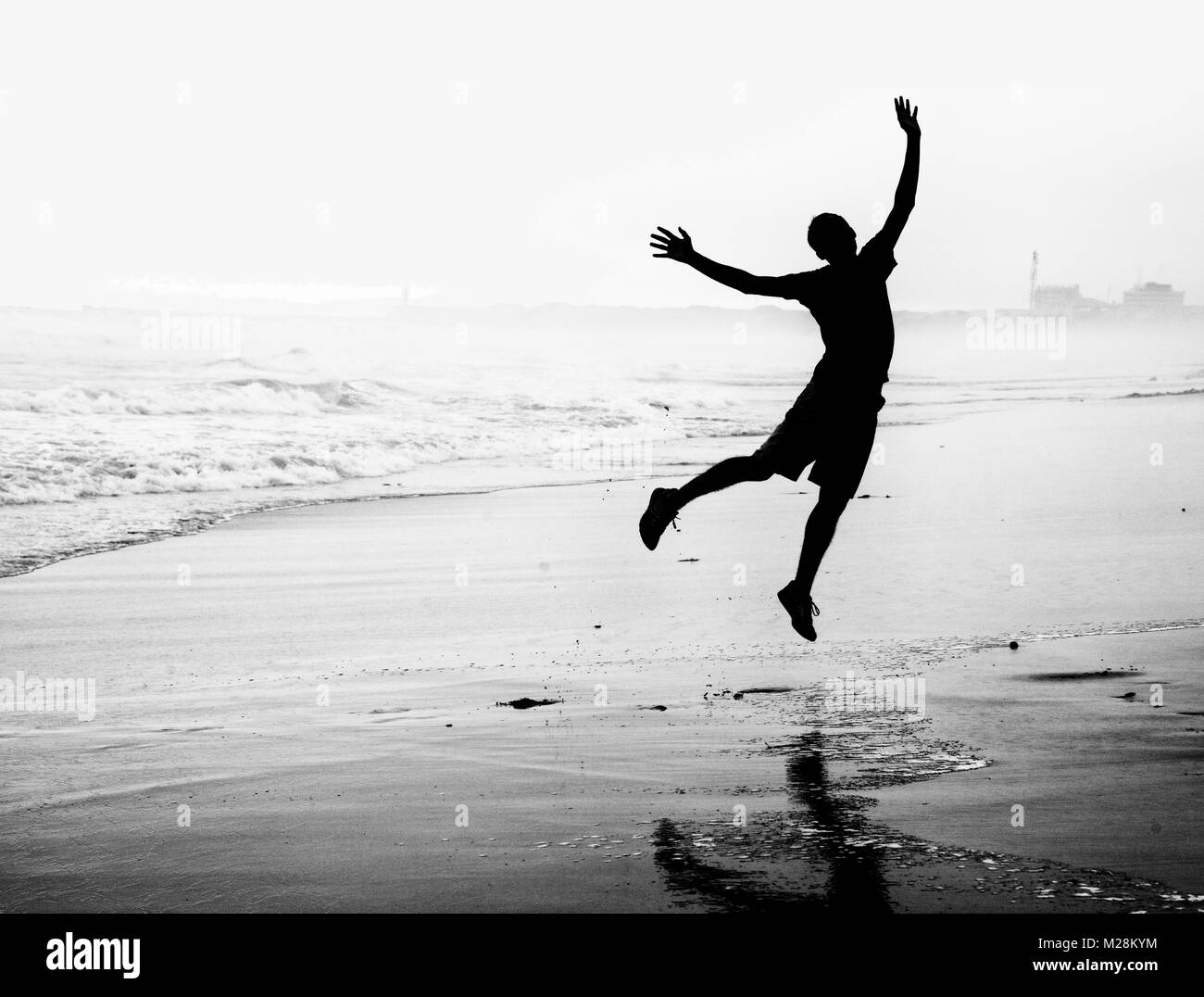 Happy young man jumping for joy Stock Photo