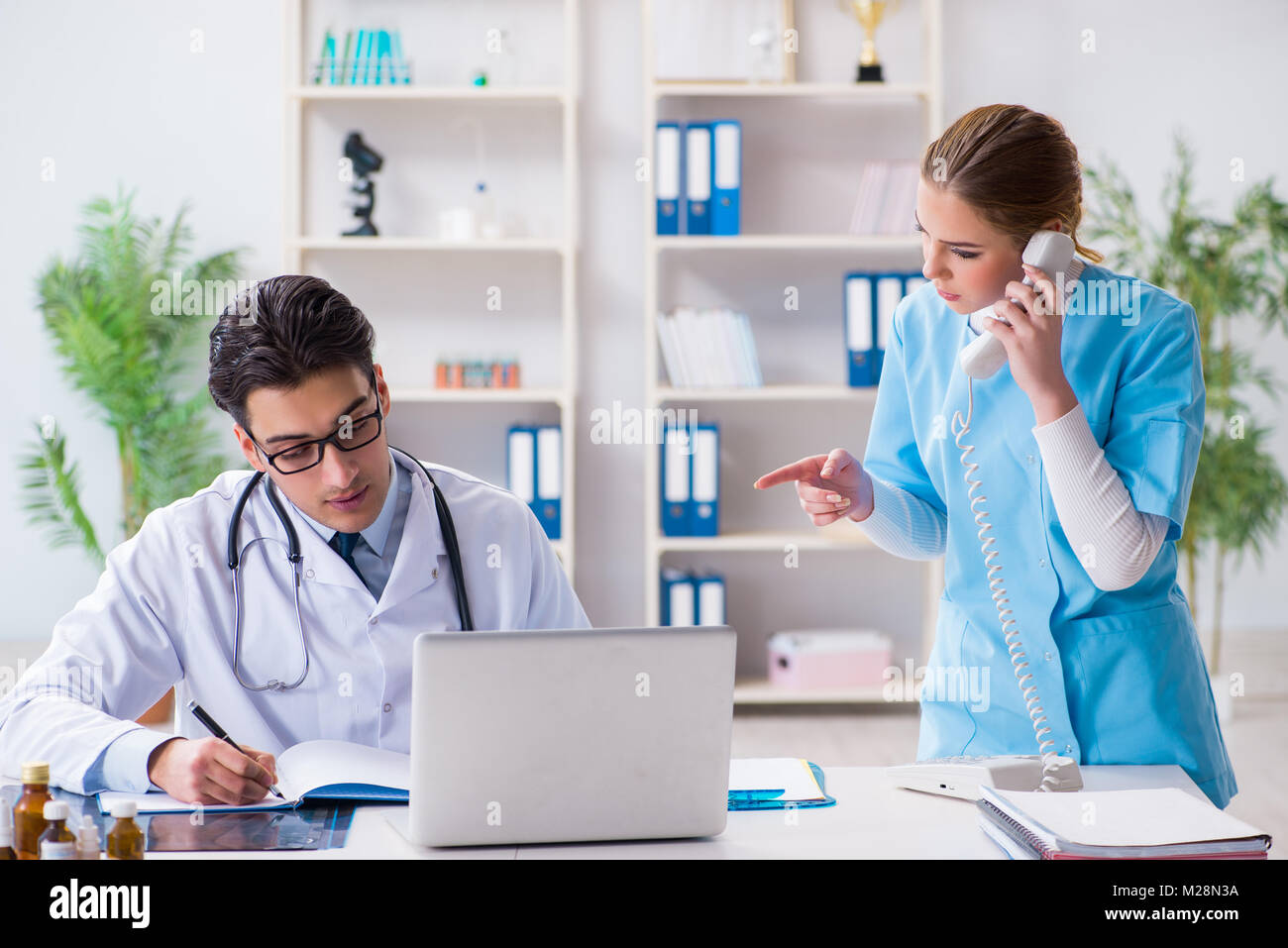Male and female doctor having discussion in hospital Stock Photo - Alamy