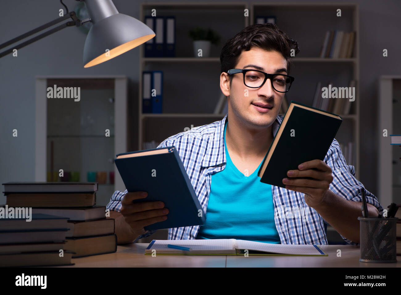 Student preparing for exams late night at home Stock Photo - Alamy