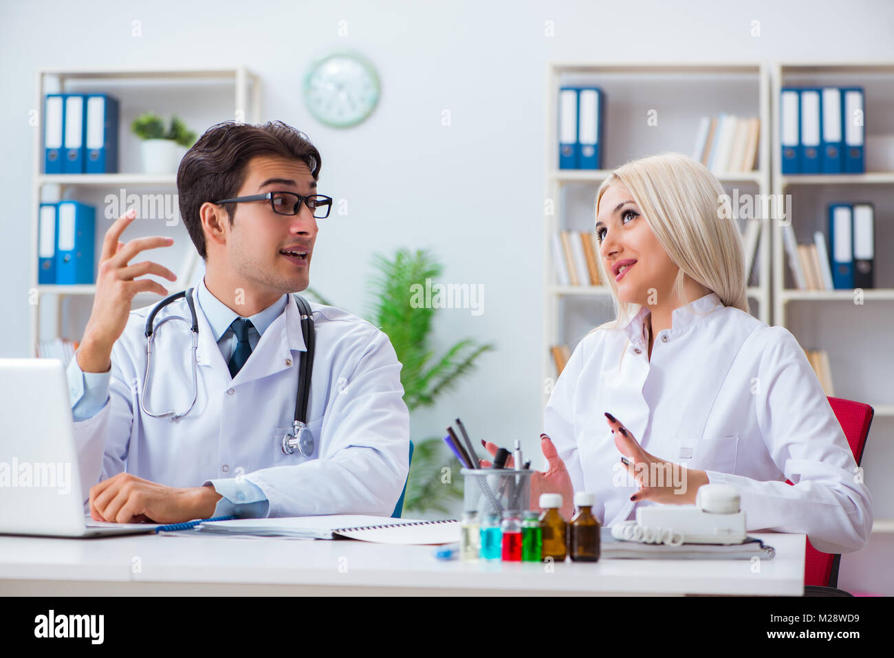 Male and female doctor having discussion in hospital Stock Photo - Alamy