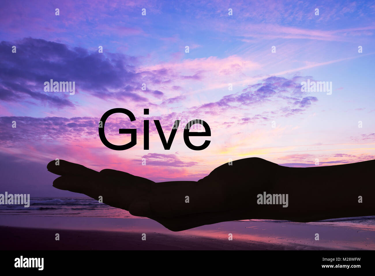 Hand offering the word give, sunset background Stock Photo