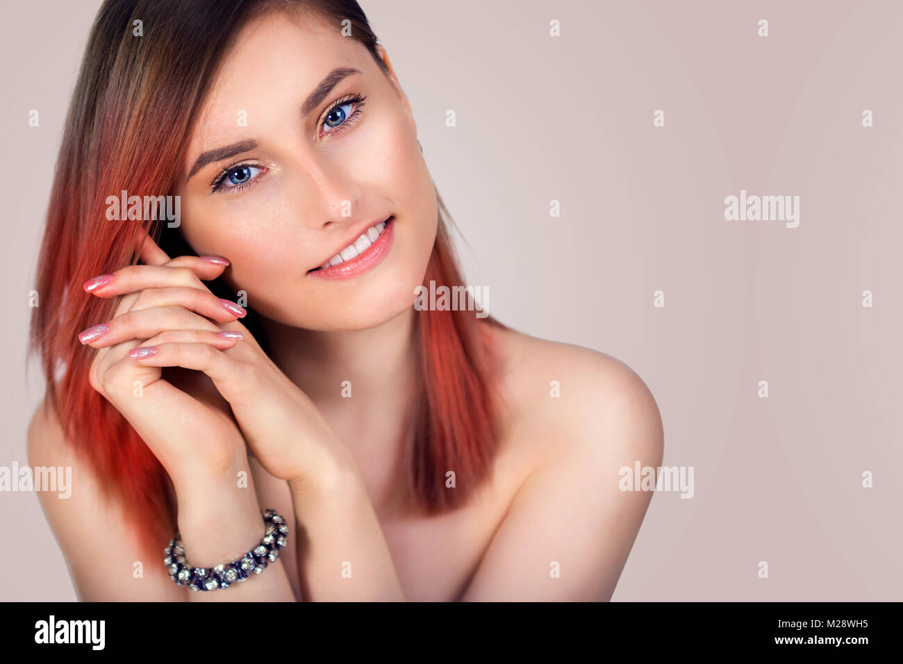 Portrait of a beautiful young smiling woman with tinted red hair Stock ...