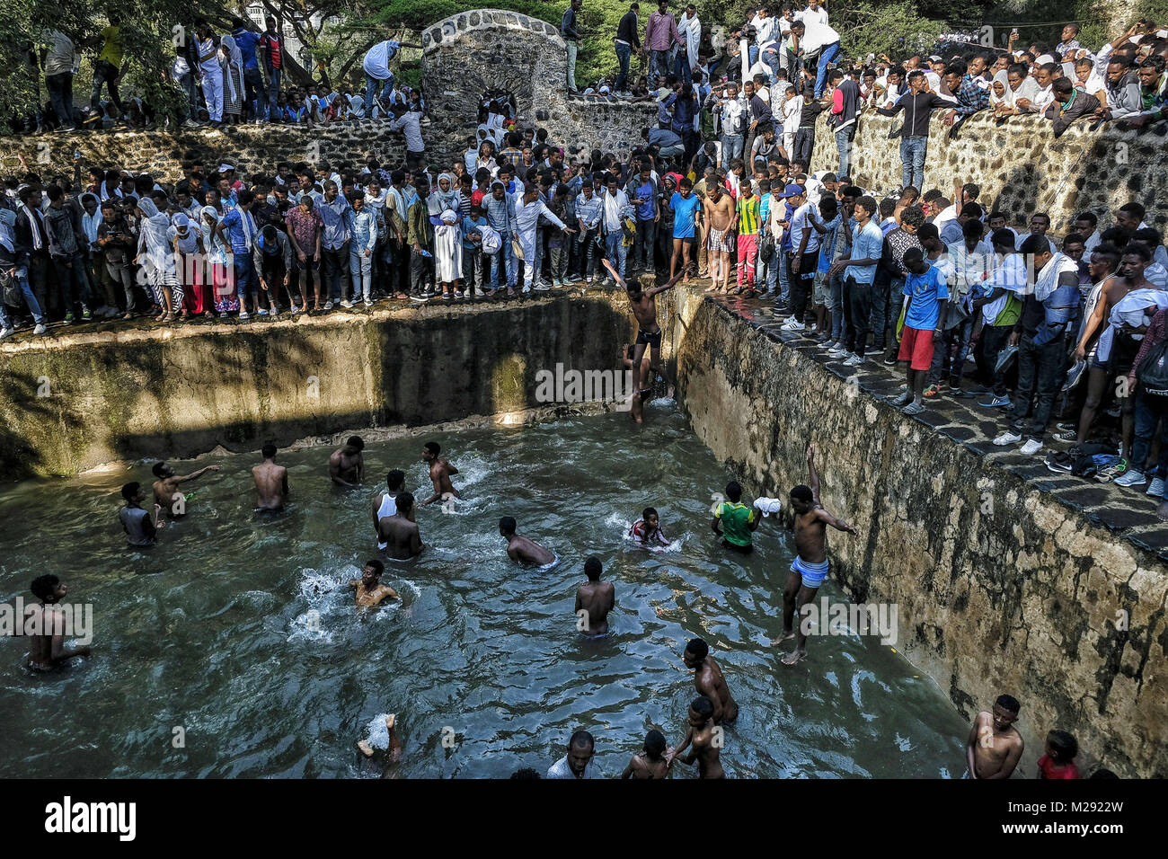 January 19, 2018 - Gondar, Amhara Region, Ethiopia - Pilgrims bathing in the waters of the Fasilides Baths..The annual Timkat festival, an Orthodox Christian celebration of Epiphany, remembers the baptism of Jesus in the Jordan river. During the festival, tabots, models of the Ark of the Covenant, are taken from churches around the city of Gondar and paraded through the streets to Fasilides Bath. Where finally the pilgrims end up bathing in the water blessed by the priests. (Credit Image: © Oscar Espinosa/SOPA via ZUMA Wire) Stock Photo