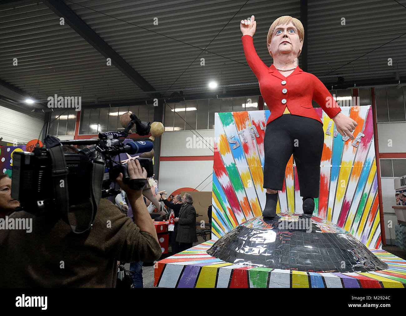 Cologne, Germany. 06th Feb, 2018. A theme wagon for the Rose Monday Parade on the topic of chancellorship stands in the wagon building hall of the Cologne Carnival's festival committee in Cologne, Germany, 06 February 2018. Credit: Oliver Berg/dpa/Alamy Live News Stock Photo