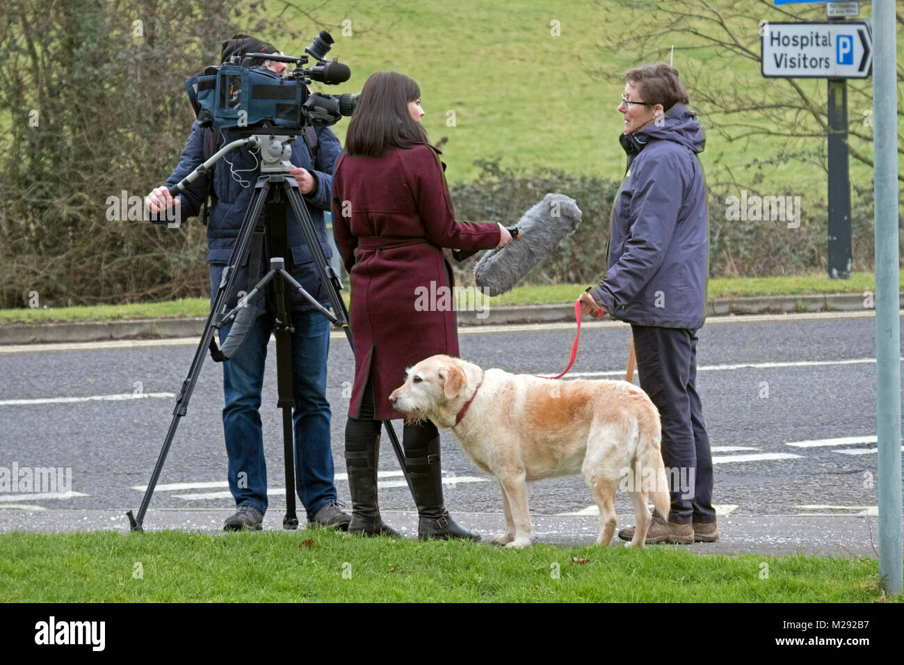 Weston-super-Mare, UK. 6th February, 2018. A reporter interviews a protestor at a demonstration against the overnight closure of the accident and emergency department at Weston General Hospital. Despite assurances that the closure is only a temporary measure, it has been in effect since July 2017, and a recent proposal for a merger between Weston Area Health NHS Trust and University Hospitals Bristol NHS Foundation Trust has created further uncertainty about Weston General Hospital’s future. Keith Ramsey/Alamy Live News Stock Photo